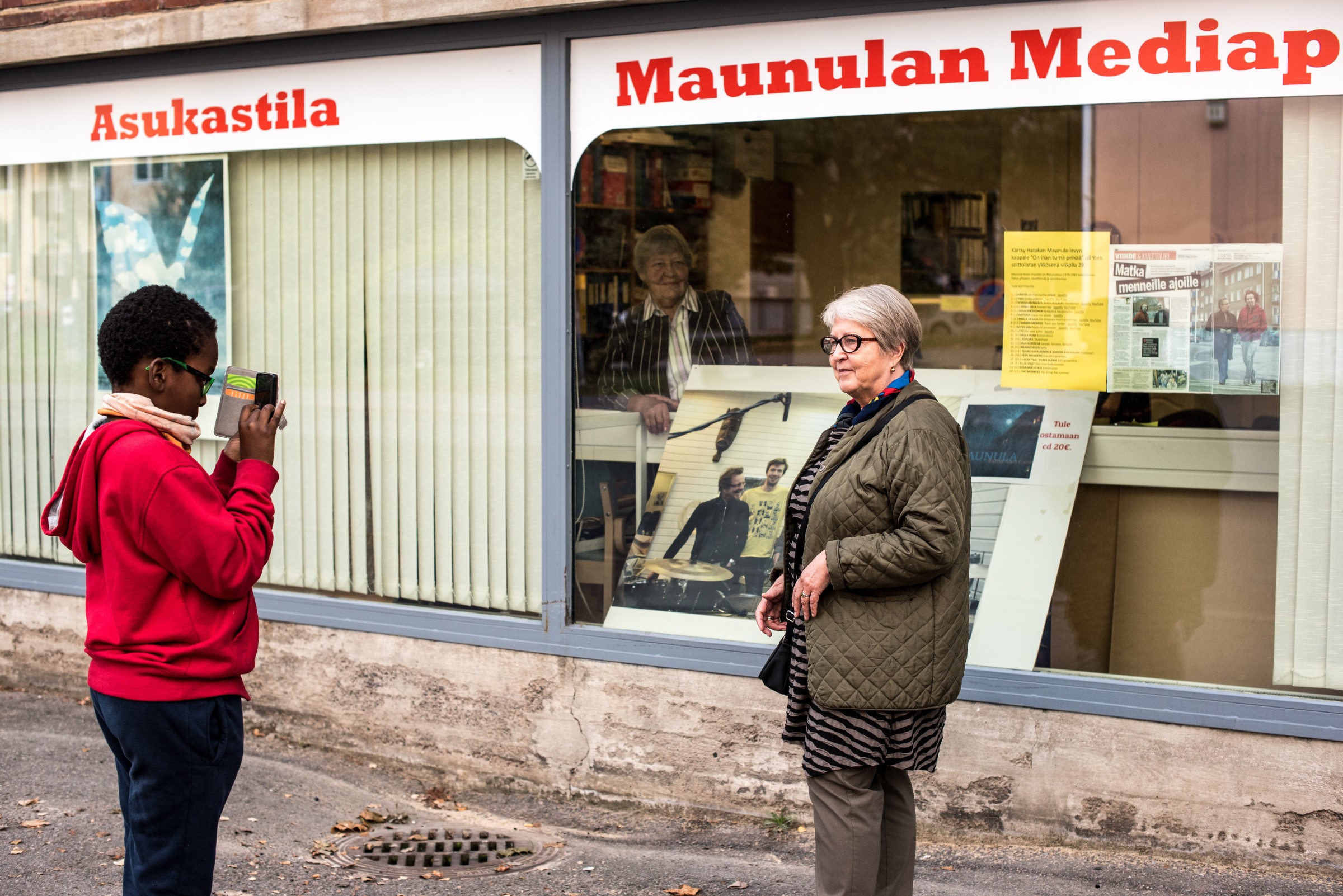 Young participant taking video of senior participant