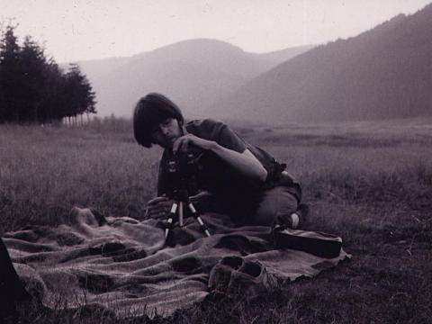 Kalle Kuisma holds camera in mountain landscape