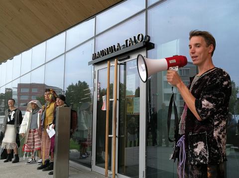 Otto Karvonen with megaphone at launch event of Maunula Collection